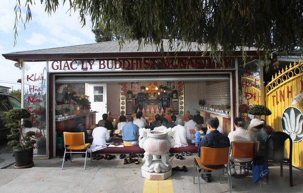 The congregation of Tinh Xa Giac Ly gathers for worship and other activities in the converted garage of a former single-family home in a residential neighborhood in Westminster. (Anne Cusack, Los Angeles Times / December 2, 2012)