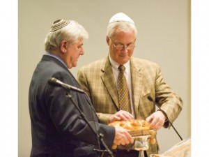 University Synagogue Rabbi Arnold Rachlis, left, gives Irvine United Congregational Church Rev. Paul Tellstrom some special holiday bread, which is part of Jewish tradition, when the two men hosted an Interfaith Thanksgiving service Tuesday night at University Synagogue.  Photo: Rod Veal