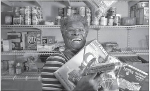 Inside the trailer that houses the Friendship Foundation Food & Clothing Pantry,  Gloria Banks shows off her wares.